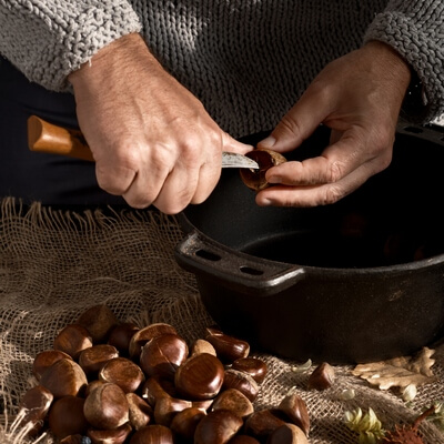 Man prepares chestnuts frying